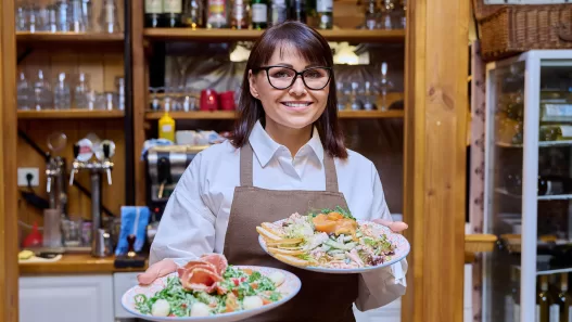 middle aged female restaurant owner in apron with