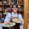 middle aged female restaurant owner in apron with