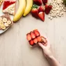 top view of woman holding fruit toast at wooden ta 2024 11 09 00 06 25 utc