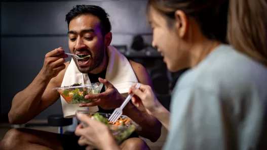 two men and women are eating a vegetable salad tog 2024 09 27 00 30 10 utc