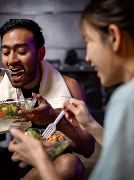 two men and women are eating a vegetable salad tog 2024 09 27 00 30 10 utc