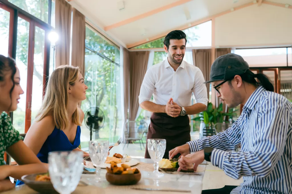 waitress man serving food to group of diverse cust 2024 09 04 00 40 35 utc