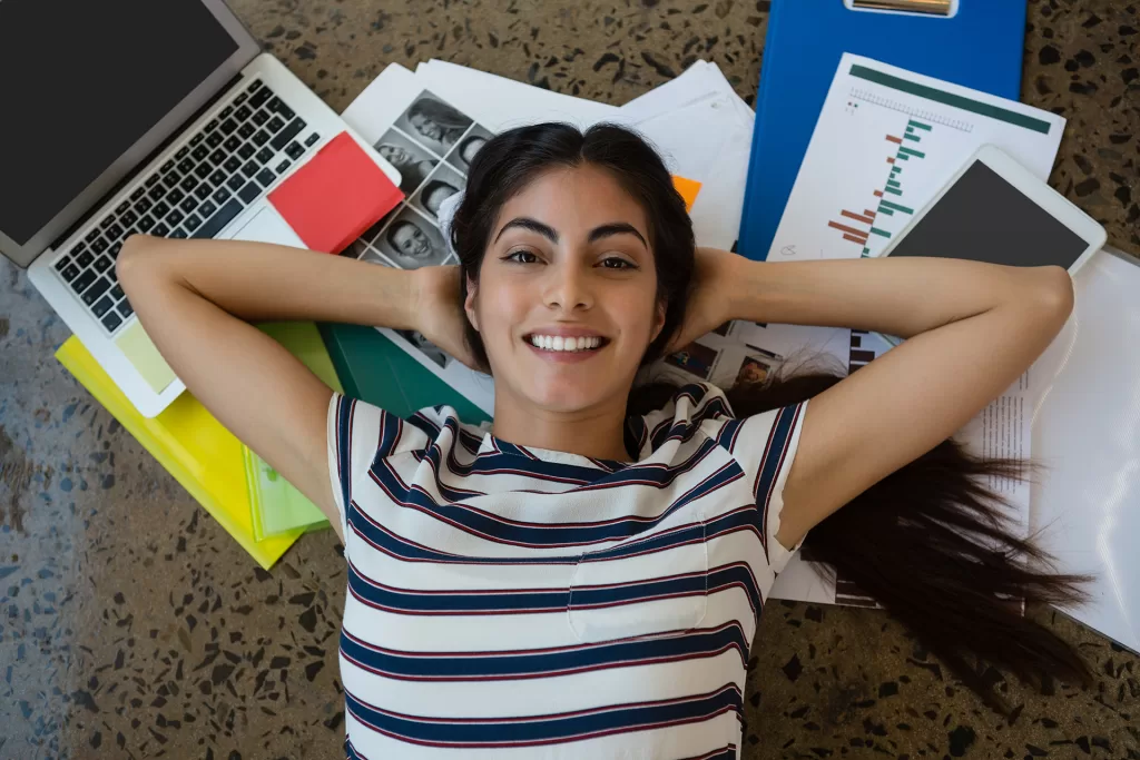 woman relaxing on documents with arms behind head 2023 11 27 05 03 17 utc