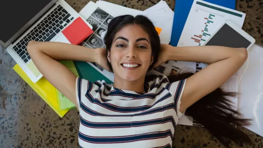 woman relaxing on documents with arms behind head 2023 11 27 05 03 17 utc