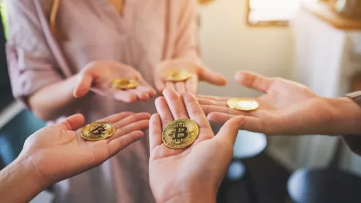 close up image of a group of people holding bitcoin