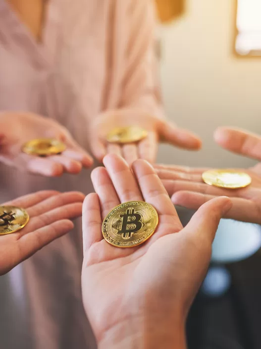 close up image of a group of people holding bitcoin